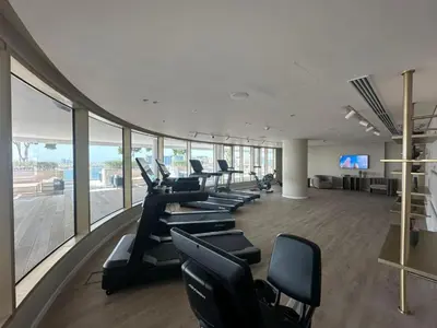 a gym with a row of chairs in a building at Grand Bleu 2 - Sophisticated Two Bed with Sea View in Dubai