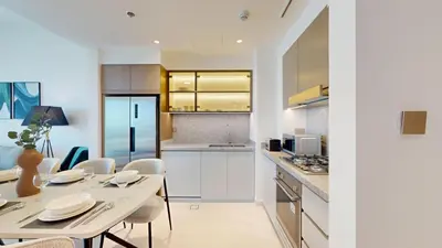 a kitchen and dining room with a table and chairs at Grand Bleu 2 - Sophisticated Two Bed with Sea View in Dubai