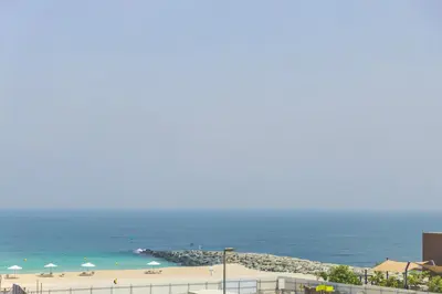 a view of a beach and the ocean at La Mer 1BR Ocean View 4 Pax in Dubai