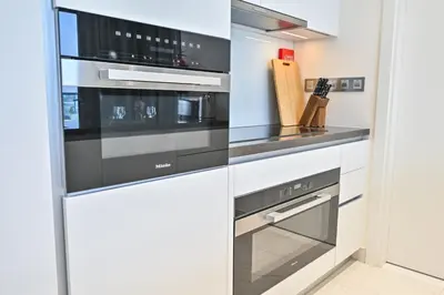 a kitchen with a stainless steel stove and oven at Chic 2BR Heart of District One in Dubai