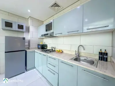 a kitchen with white cabinets and a sink at Amazing New Design Flat with Rooftop Pool in Dubai Marina 5 pax in Dubai