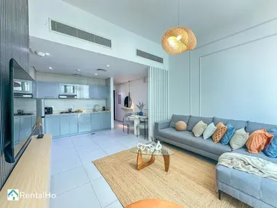 a living room with a couch and a table at Amazing New Design Flat with Rooftop Pool in Dubai Marina 5 pax in Dubai