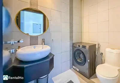 a bathroom with a sink and a washing machine at Amazing New Design Flat with Rooftop Pool in Dubai Marina 5 pax in Dubai