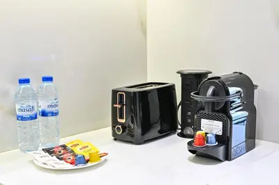 a kitchen counter with a coffee maker and a toaster at Stunning 1 br modern luxury residence at JVC in Dubai