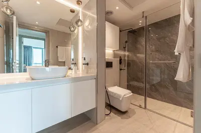 a white bathroom with a sink and a shower at HAVN - Upgraded 1 Bed in 8 Boulevard Walk Downtown in Dubai