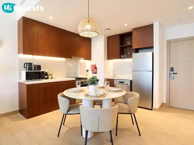 a kitchen and dining room with a table and chairs at HiGuests - Seaside Serenity 1 BR at Port De La Mer in Dubai