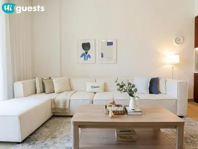 a living room with a white couch and a coffee table at HiGuests - Seaside Serenity 1 BR at Port De La Mer in Dubai