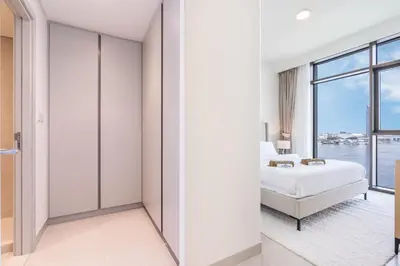a bedroom with a bed and a view of the water at Brand New Creek Home with Panoramic Water View in Dubai