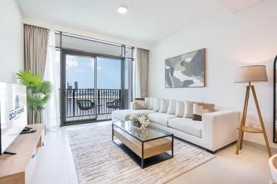 a living room with a couch and a glass table at Brand New Creek Home with Panoramic Water View in Dubai