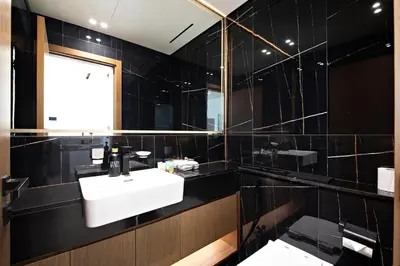 a bathroom with a sink and a mirror at Stylish 1BR Apartment in Binghatti Onyx JVC in Dubai