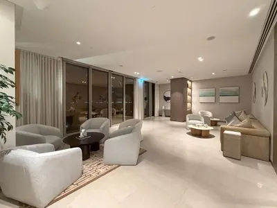 a living room with chairs and a couch and a table at Full Burj Khalifa and Fountain View from All Rooms in Dubai