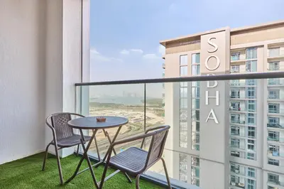 a balcony with a table and chairs and a view of a building at STAY BY LATINEM Luxury 1BR Holiday Home CVG 3204 Near Burj Khalifa in Dubai