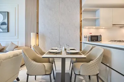 a dining room with a table and chairs at STAY BY LATINEM Luxury 1BR Holiday Home CVG 3204 Near Burj Khalifa in Dubai