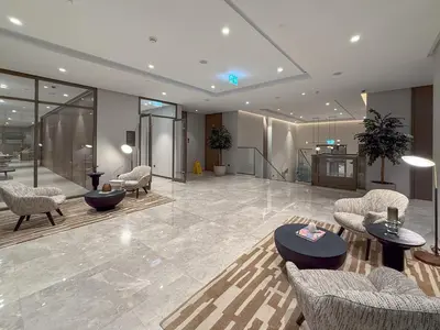 a lobby with chairs and tables in a building at Burj & Fountain View Retreat in Dubai