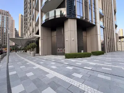 an empty sidewalk in front of a building at Burj & Fountain View Retreat in Dubai
