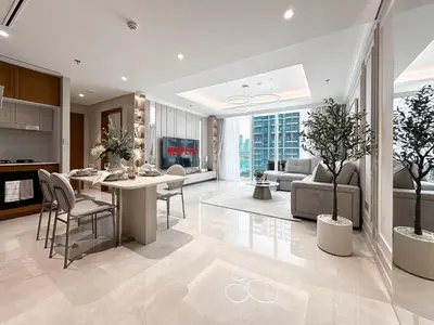 a kitchen and living room with a table and chairs at Seaside Elegance 1BR Luxury Apartment with Private Beach Access, Emaar Beachfront in Dubai
