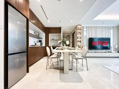 a kitchen and dining room with a white table and chairs at Seaside Elegance 1BR Luxury Apartment with Private Beach Access, Emaar Beachfront in Dubai