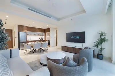 a living room with a table and chairs at ALiving Classy 1BR I Stunning Views I Emaar Palace Beach Residence in Dubai