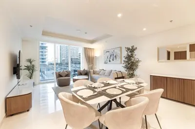 a living room with a table and chairs at ALiving Classy 1BR I Stunning Views I Emaar Palace Beach Residence in Dubai