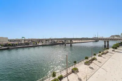 a view of a river with a bridge in the background at 2BR Canal Front B3, Canal Views in Dubai