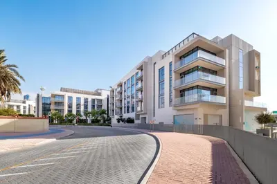 a building on a street next to a road at 2BR Canal Front B3, Canal Views in Dubai
