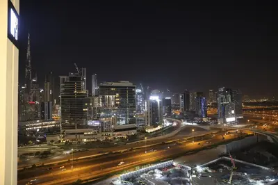 a night view of a city with traffic at Brand New Large 2 Bedroom with Burj Khalifa view in Dubai