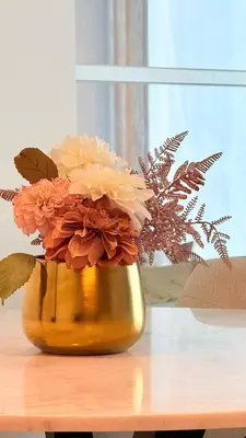 a vase filled with flowers sitting on a table at One bedroom Full view Dubai Hills in Dubai