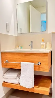a bathroom with a sink and a mirror and towels at One bedroom Full view Dubai Hills in Dubai