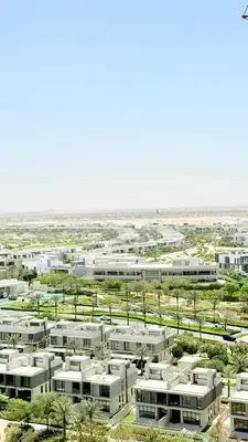 an aerial view of a city with white buildings at One bedroom Full view Dubai Hills in Dubai
