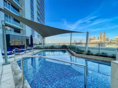a swimming pool on the roof of a building at Luxurious 1BR in Palm View with Palm Jumeirah Views in Dubai