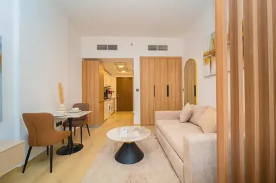 a living room with a couch and a table at Elegant JVC Stay Luxury Amid Nature in Dubai