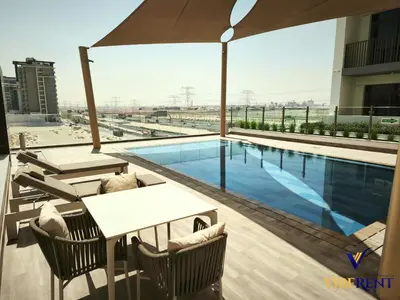 a swimming pool on the roof of a building at 2BR Sofa Bed Sleep 6 Furjan in Dubai