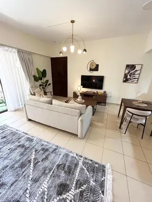 a living room with a couch and a table at Beachside Spacious Studio at the heart of JBR in Dubai