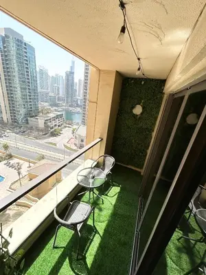 a balcony with two chairs and a table on a building at Beachside Spacious Studio at the heart of JBR in Dubai
