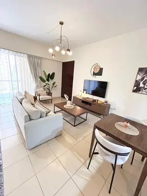 a living room with a couch and a table at Beachside Spacious Studio at the heart of JBR in Dubai