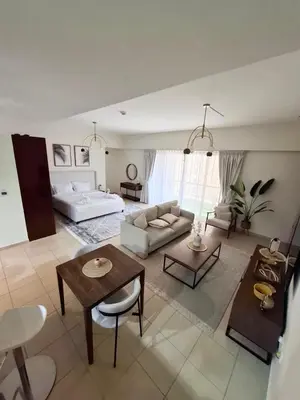 a living room with a couch and a table at Beachside Spacious Studio at the heart of JBR in Dubai