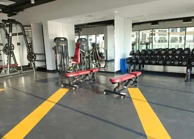 a gym with a bunch of bikes and weights at The Nook 2 - 2 bed flat near Dubai Marina in Dubai