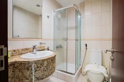 a bathroom with a shower and a sink and a toilet at 13P-Sea View Apartment in Dubai Marina with Pool & Balcony in Dubai