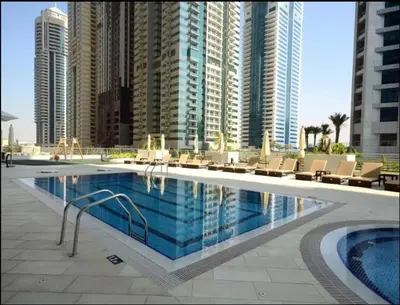 a swimming pool in a city with tall buildings at 13P-Sea View Apartment in Dubai Marina with Pool & Balcony in Dubai