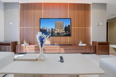 a living room with a vase of flowers on a table at 13P-Sea View Apartment in Dubai Marina with Pool & Balcony in Dubai