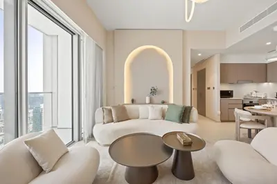 a living room with a couch and a table at Elite Escapes - 2 BHK Luxurious - Grande Signature in Dubai