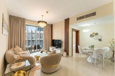 a living room with a couch and a table at Stand Point Residence by Hogar in Dubai