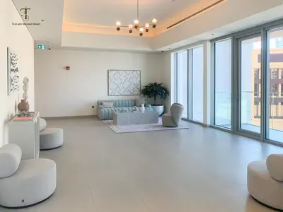 a living room with a couch and chairs and windows at Swanky Suite Forte T1 2BR Downtown in Dubai