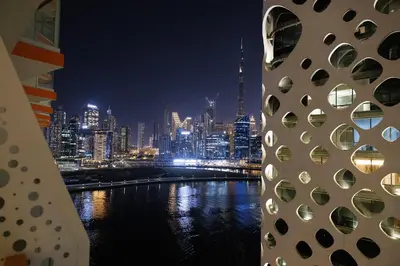 a view of a city skyline at night at Luxury 1BR Apartment with Burj Khalifa&Canal view in Dubai