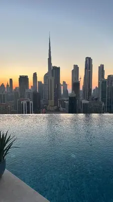 a swimming pool with a view of a city skyline at Luxury 1BR Apartment with Burj Khalifa&Canal view in Dubai