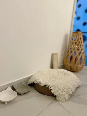 a white rug sitting on a floor next to a table at Luxury 1BR Apartment with Burj Khalifa&Canal view in Dubai