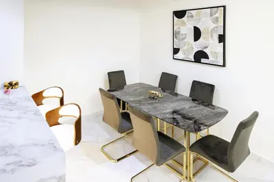 a dining room with a marble table and chairs at Luxury 1BR Apartment with Burj Khalifa&Canal view in Dubai