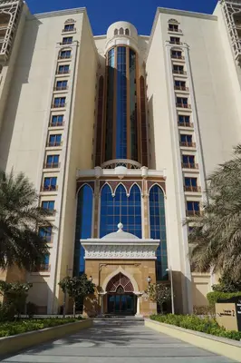 a large building with a gate in front of it at PJ- Premium Palm Jumeirah Apartment - Beachfront, Pool & Balcony in Dubai