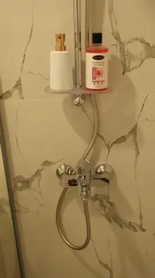 a shower head with a hose in a bathroom at 1BHK Holiday Location in Dubai
