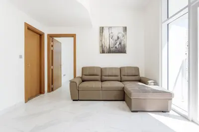 a living room with a couch and a table at 5 Min Downtown in Dubai